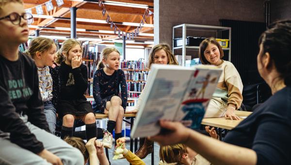 begeleider leest boek voor